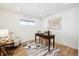 Basement home office with wood desk and light flooring at 14800 Foothill Rd, Golden, CO 80401