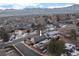 High definition aerial view of the property, nestled in an established neighborhood with mountain backdrop at 2490 S Coors St, Lakewood, CO 80228