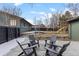 Landscaped backyard featuring a patio with seating, a yard, and a view of the home's exterior at 2490 S Coors St, Lakewood, CO 80228