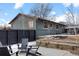 Backyard view featuring a patio with seating and rock landscaping at 2490 S Coors St, Lakewood, CO 80228