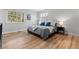 Bright bedroom with hardwood floors, large windows, and minimalist decor at 2490 S Coors St, Lakewood, CO 80228