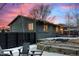 Dusk exterior of home with backyard patio, landscaping, yard, and modern paint job at 2490 S Coors St, Lakewood, CO 80228