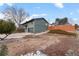 View of the home's side exterior and garage, complete with a driveway and landscaped yard at 2490 S Coors St, Lakewood, CO 80228