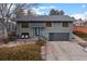 Charming two-story home with a modern gray exterior, updated windows, and a stylish garage door at 2490 S Coors St, Lakewood, CO 80228