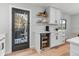 Kitchenette space featuring built-in refrigerator, white shaker cabinets and shelves, and an outdoor view at 2490 S Coors St, Lakewood, CO 80228