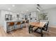 Modern kitchen featuring white cabinets, stainless steel appliances, a large island, and an adjacent dining area at 2490 S Coors St, Lakewood, CO 80228