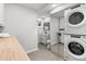 Well-lit laundry room featuring a washer and dryer set, ample counter space, and built-in storage solutions at 2490 S Coors St, Lakewood, CO 80228