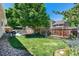 Large backyard featuring mature trees, lush lawn, and patio area at 5332 S Lisbon Way, Centennial, CO 80015