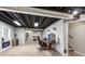 Finished basement featuring a home office, fireplace, and exposed ceiling at 5332 S Lisbon Way, Centennial, CO 80015