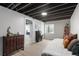 Finished basement area with exposed ceiling, laminate floors, and neutral colors at 5332 S Lisbon Way, Centennial, CO 80015