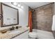 Bathroom featuring granite countertop, tiled shower, and bronze fixtures at 5332 S Lisbon Way, Centennial, CO 80015