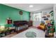 Bright Bedroom with green accent wall, dark wood crib, and playful decor at 5332 S Lisbon Way, Centennial, CO 80015