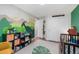 A themed bedroom featuring a dinosaur mural, natural lighting, and a playful atmosphere at 5332 S Lisbon Way, Centennial, CO 80015