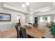 Open-concept dining room with hardwood floors, vaulted ceilings, and stylish lighting fixtures at 5332 S Lisbon Way, Centennial, CO 80015