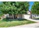 Charming home featuring a well-manicured lawn and a large tree, providing shade and curb appeal at 5332 S Lisbon Way, Centennial, CO 80015