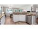 Bright kitchen featuring granite countertops, white cabinets, and a stainless steel dishwasher at 5332 S Lisbon Way, Centennial, CO 80015