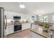 Spacious kitchen with granite countertops, white cabinets, stainless steel appliances, and recessed lighting at 5332 S Lisbon Way, Centennial, CO 80015