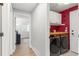 Convenient laundry area with modern washer and dryer, and bright red wall at 5332 S Lisbon Way, Centennial, CO 80015