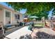 Outdoor patio with seating, mature trees, and fence at 5332 S Lisbon Way, Centennial, CO 80015