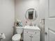 Clean powder room features a vanity with a round mirror and fresh decor at 6376 E Mississippi Ave, Denver, CO 80224