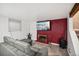 Contemporary living room with brick fireplace, and a modern grey sofa at 6376 E Mississippi Ave, Denver, CO 80224