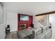 Contemporary living room with brick accent wall and a stylish grey sofa at 6376 E Mississippi Ave, Denver, CO 80224