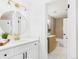 Bright bathroom featuring a round mirror, modern lighting, and a vanity with white countertop at 7205 S Gaylord St # G, Centennial, CO 80122