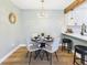 Bright dining room featuring a modern light fixture and view to the kitchen at 7205 S Gaylord St # G, Centennial, CO 80122