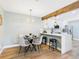 Bright dining room featuring a modern light fixture and view to the kitchen at 7205 S Gaylord St # G, Centennial, CO 80122
