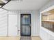 Apartment entrance with security door, and view to kitchen through the window at 7205 S Gaylord St # G, Centennial, CO 80122