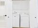 Convenient laundry closet with a white washer and dryer, and a built-in shelf for storage at 7205 S Gaylord St # G, Centennial, CO 80122