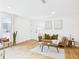 Bright living room featuring a leather sofa, wood floors, and modern decor at 7205 S Gaylord St # G, Centennial, CO 80122