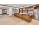 Finished basement bar with wood bar, brick backsplash, stainless steel appliances, and light hardwood floors at 1525 W 141St Way, Westminster, CO 80023