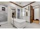 Bright bathroom with soaking tub, glass shower, marble and custom cabinets at 1525 W 141St Way, Westminster, CO 80023