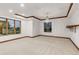 Primary bedroom with tray ceiling, chandelier lighting, wood trim, large windows and decorative shelf at 1525 W 141St Way, Westminster, CO 80023