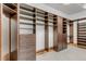 Custom closet with wood shelving, drawers, and carpet at 1525 W 141St Way, Westminster, CO 80023