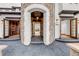 Elegant home entrance with a stone archway, showcasing the craftsmanship and attention to detail at 1525 W 141St Way, Westminster, CO 80023