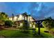 Large two-story home with stone facade, beautiful landscaping, and backyard swing set at twilight at 1525 W 141St Way, Westminster, CO 80023