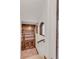 Charming hallway with a built-in wooden bookcase, arched windows, and staircase at 1525 W 141St Way, Westminster, CO 80023