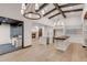 Spacious kitchen featuring two islands, exposed beams, modern lighting, and a fireplace, offering a luxurious cooking and dining area at 1525 W 141St Way, Westminster, CO 80023