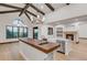 Open kitchen with island, farm sink, wood floors, and stone fireplace at 1525 W 141St Way, Westminster, CO 80023