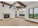 Bright living room featuring wooden beams, fireplace, hardwood floors and large windows at 1525 W 141St Way, Westminster, CO 80023