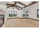 Spacious living room with fireplace, wood floors, wooden beams and bright windows at 1525 W 141St Way, Westminster, CO 80023