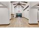 Great room with high ceiling, wooden beams, stone fireplace, and french doors at 1525 W 141St Way, Westminster, CO 80023