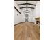 Great room with high ceiling, wooden beams, stone fireplace, and wood floors at 1525 W 141St Way, Westminster, CO 80023