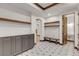 Mudroom with gray cabinetry, a bench, and an ornate mosaic tile floor providing a stylish and functional space for entry and storage at 1525 W 141St Way, Westminster, CO 80023