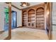 Office with custom wood built-ins and natural light from the outdoor access, perfect for work or study at 1525 W 141St Way, Westminster, CO 80023