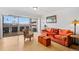 Bright living room with city view, featuring orange couch and comfy chair at 800 N Washington St # 710, Denver, CO 80203