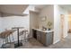 Finished basement bar area with modern cabinets, sink, beverage cooler, seating, and stylish decor at 222 S Monroe St, Denver, CO 80209