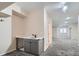 Basement wet bar area with a sink, cabinets, and a spacious carpeted floor at 222 S Monroe St, Denver, CO 80209